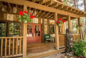 a porch with red flowers